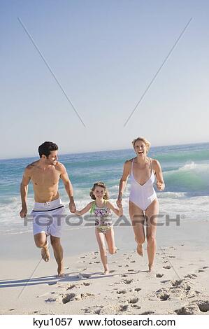 Stock Photo - Family enjoying vacations on the beach. Fotosearch