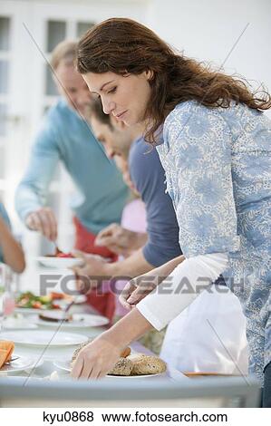 Stock Photo - Family having breakfast at the dining table. Fotosearch
