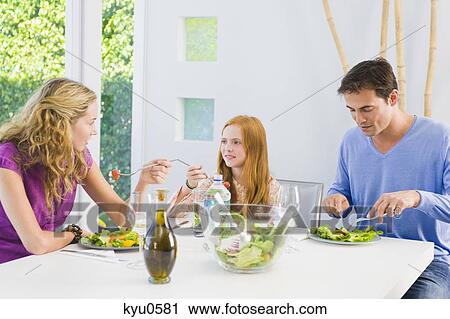 Family having lunch View Large Photo Image Stock Image - Family having lunch. Fotosearch