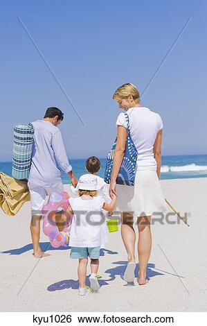 Stock Photograph - Family on vacations on the beach. Fotosearch