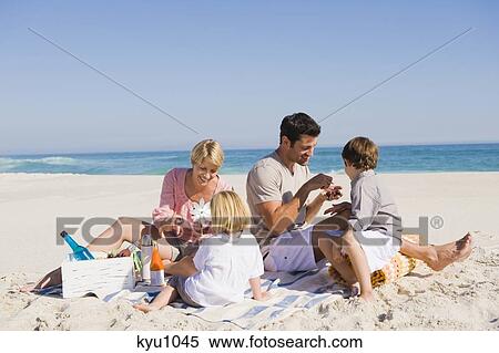 Stock Photography - Family on vacations on the beach. Fotosearch