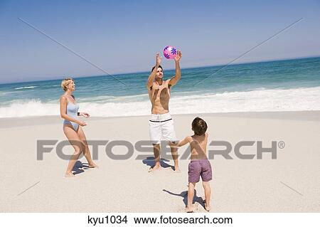 Family playing with a beach ball View Large Photo Image Picture - Family playing with a beach ball. Fotosearch
