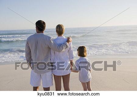 Family standing on the beach View Large Photo Image Stock Image - Family standing on the beach. Fotosearch