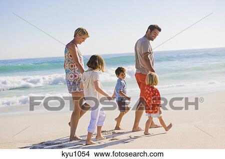 Family walking on the beach View Large Photo Image Picture - Family walking on the beach. Fotosearch