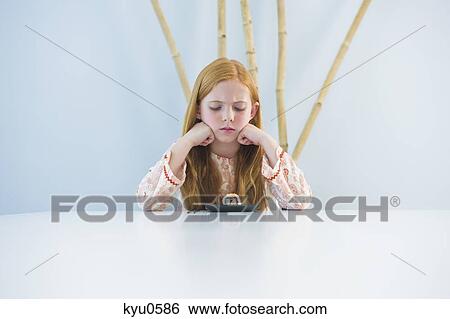 Girl at the dining table View Large Photo Image Stock Photograph - Girl at the dining table. Fotosearch