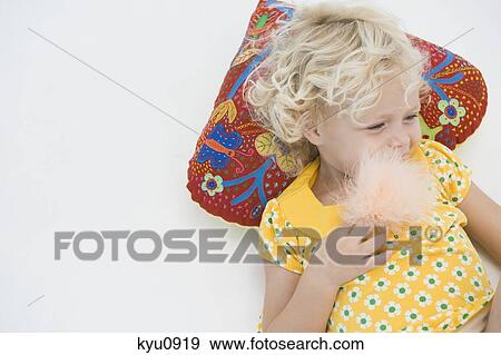 Girl eating cotton candy View Large Photo Image Stock Photo - Girl eating cotton candy. Fotosearch