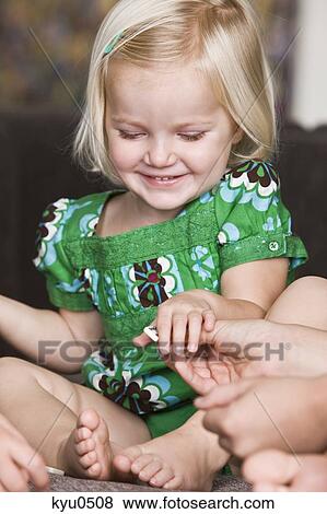 Girl holding a domino and smiling View Large Photo Image Stock Photo - Girl holding a domino and smiling. Fotosearch