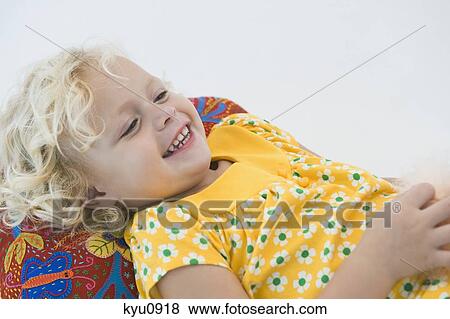 Girl lying and smiling View Large Photo Image Stock Photo - Girl lying and smiling. Fotosearch