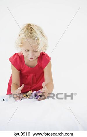 Girl playing with artificial butterflies View Large Photo Image Stock Photograph - Girl playing with artificial butterflies. Fotosearch