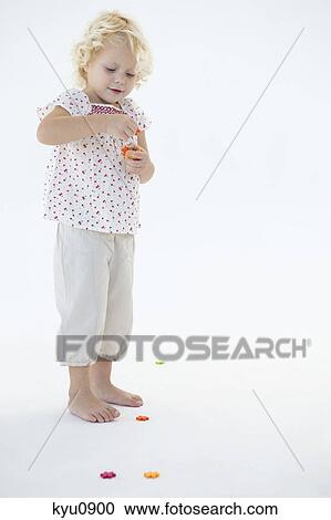 Stock Image - Girl playing with flowers. Fotosearch