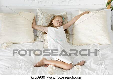 Girl sleeping on the bed View Large Photo Image Stock Image - Girl sleeping on the bed. Fotosearch