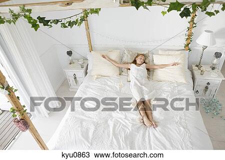 High angle view of a flower girl sleeping on the bed View Large Photo Image Stock Image - High angle view of a flower girl sleeping on the bed. Fotosearch