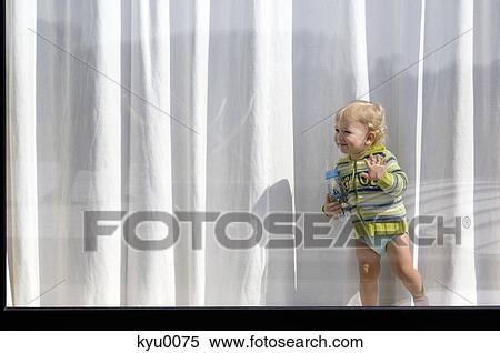 Little boy standing behind window View Large Photo Image Stock Photography - Little boy standing behind window. Fotosearch