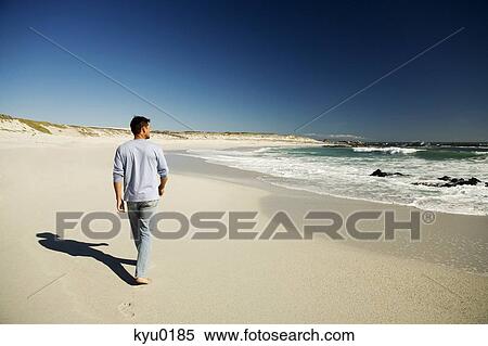 Ma walking on the beach, rear view View Large Photo Image Stock Photography - Ma walking on the beach, rear view. Fotosearch