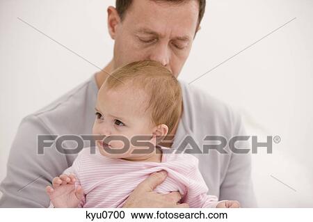 Man carrying his daughter View Large Photo Image Stock Image - Man carrying his daughter. Fotosearch
