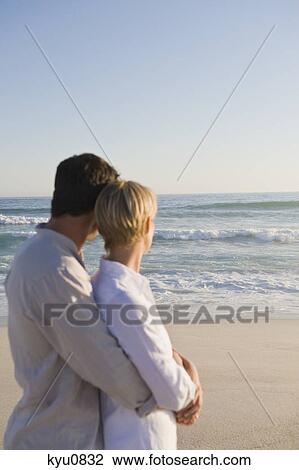 Man embracing a woman from behind View Large Photo Image Stock Image - Man embracing a woman from behind. Fotosearch