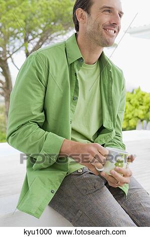 Man holding a coffee cup and smiling View Large Photo Image Stock Image - Man holding a coffee cup and smiling. Fotosearch