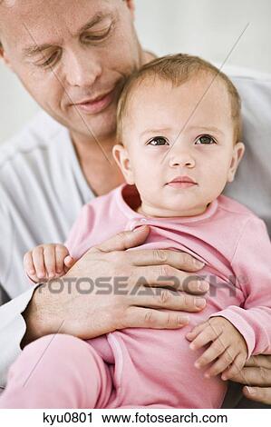 Stock Image - Man holding his daughter. Fotosearch