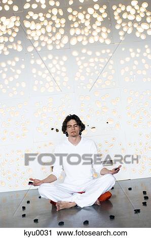 Man in yoga position, sitting cross-legged View Large Photo Image Stock Image - Man in yoga position, sitting cross-legged. Fotosearch