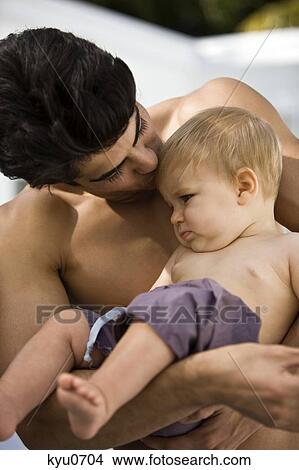 Picture - Man kissing his son. Fotosearch