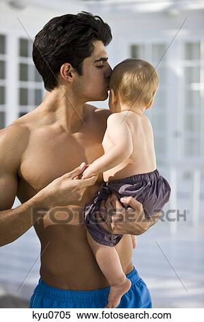 Stock Photography - Man kissing his son. Fotosearch