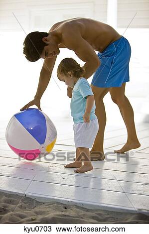 Stock Image - Man playing with his daughter. Fotosearch