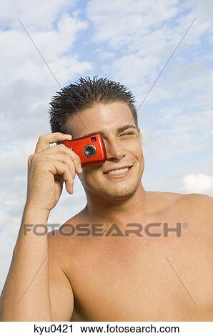 Man taking a picture with a digital camera View Large Photo Image Stock Image - Man taking a picture with a digital camera. Fotosearch