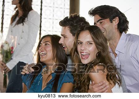 Men smiling with two women View Large Photo Image Stock Image - Men smiling with two women. Fotosearch