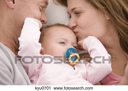 Parents kissing their daughter View Large Photo Image Stock Image - Parents kissing their daughter. Fotosearch