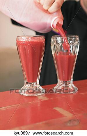 Person pouring bloody mary into glasses View Large Photo Image Stock Photo - Person pouring bloody mary into glasses. Fotosearch