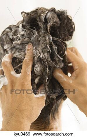 Stock Photo - Person's hands shampooing a woman's hair. Fotosearch