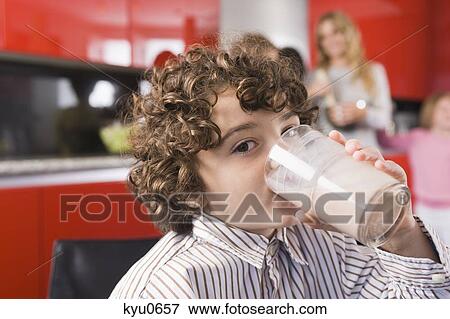 Portrait of a boy drinking a glass of milk View Large Photo Image Stock Photo - Portrait of a boy drinking a glass of milk. Fotosearch