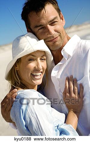 Portrait of a couple embracing, on the beach View Large Photo Image Stock Photo - Portrait of a couple embracing, on the beach. Fotosearch