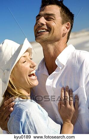 Portrait of a couple embracing, on the beach View Large Photo Image Stock Photo - Portrait of a couple embracing, on the beach. Fotosearch
