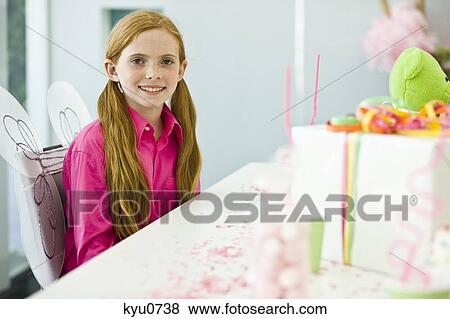 Stock Photo - Portrait of a girl celebrating her birthday. Fotosearch