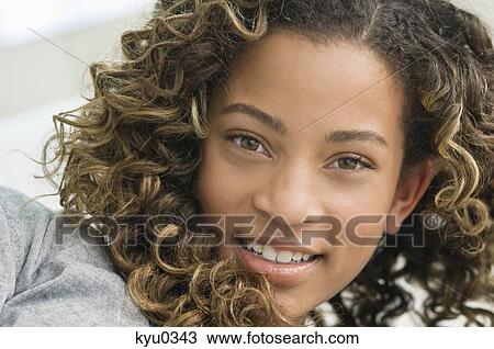 Stock Image - Portrait of a girl smiling. Fotosearch