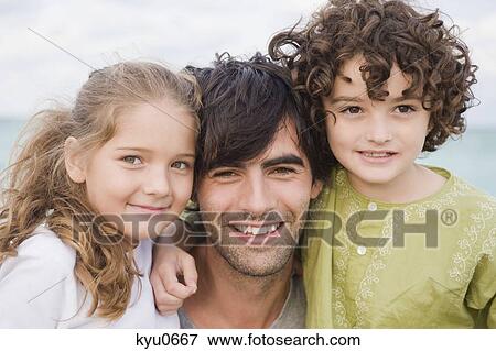 Stock Photo - Portrait of a man with his children. Fotosearch