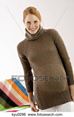 Portrait of a pregnant young woman standing and smiling View Large Photo Image Stock Photograph - Portrait of a pregnant young woman standing and smiling. Fotosearch