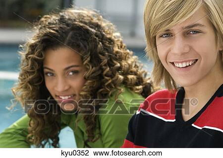 Portrait of a teenage boy smiling with a girl View Large Photo Image Stock Image - Portrait of a teenage boy smiling with a girl. Fotosearch