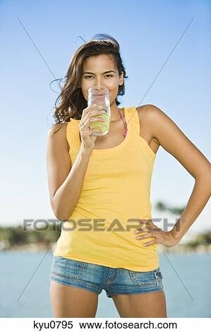 Portrait of a woman drinking lemonade View Large Photo Image Stock Photography - Portrait of a woman drinking lemonade. Fotosearch