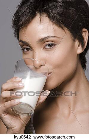 Portrait of a woman drinking milk from a glass View Large Photo Image Stock Image - Portrait of a woman drinking milk from a glass. Fotosearch