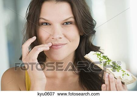 Portrait of a woman eating a bread View Large Photo Image Stock Photo - Portrait of a woman eating a bread. Fotosearch