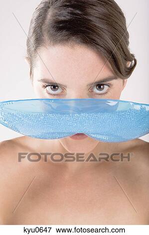 Portrait of a woman holding an eye mask in front of her face View Large Photo Image Stock Photo - Portrait of a woman holding an eye mask in front of her face. Fotosearch