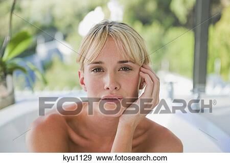 Stock Photo - Portrait of a woman in a bathtub. Fotosearch