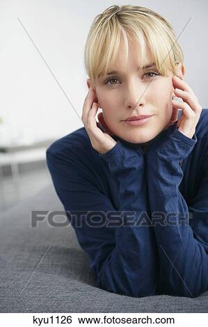Stock Photograph - Portrait of a woman lying on the bed. Fotosearch