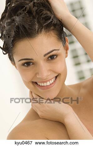 Portrait of a woman shampooing her hair View Large Photo Image Stock Photo - Portrait of a woman shampooing her hair. Fotosearch