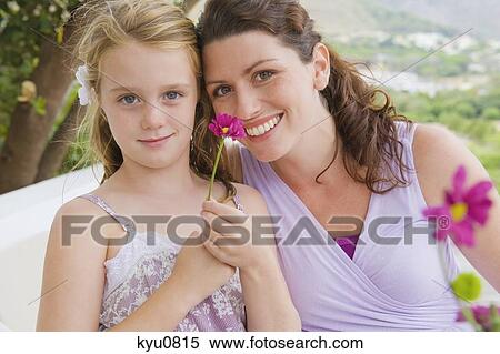 Stock Photography - Portrait of a woman smiling with her daughter. Fotosearch