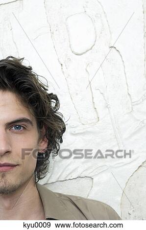 Portrait of a young man looking at the camera View Large Photo Image Stock Photo - Portrait of a young man looking at the camera. Fotosearch