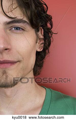 Portrait of a young man looking at the camera View Large Photo Image Stock Photo - Portrait of a young man looking at the camera. Fotosearch