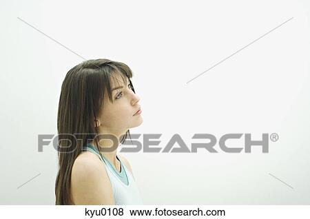 Stock Photo - Portrait of a young thinking woman, in profil. Fotosearch